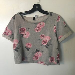 Grey crop top with pink flower details.